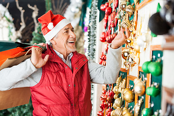 Image showing Man Buying Christmas Ornaments At Store