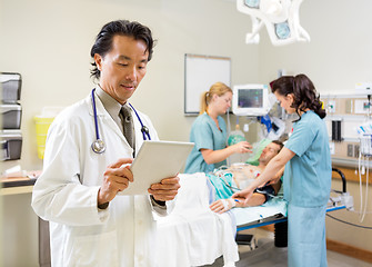 Image showing Medical Team Treating Patient In Hospital