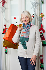 Image showing Senior Woman With Shopping Bags During Christmas