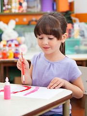 Image showing Girl Painting At Desk In Art Class