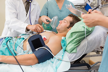 Image showing Doctor And Nurses Examining Critical Patient