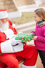 Image showing Girl Receiving Present From Santa Claus