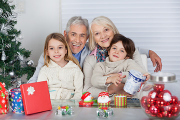 Image showing Children And Grandparents With Christmas Gifts