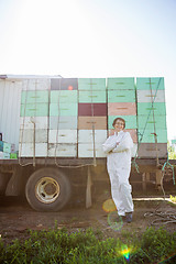 Image showing Beekeeper Standing Against Truck Loaded With Honeycomb Crates