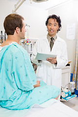 Image showing Doctor Holding Digital Tablet With Patient Sitting On Bed