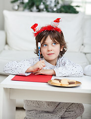 Image showing Thoughtful Boy With Pencil And Cardpaper