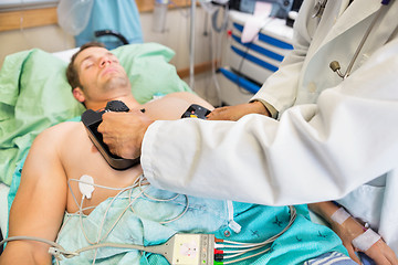 Image showing Doctor Defibrillating Patient In Emergency