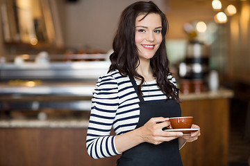 Image showing Beautiful Waitress Holding Coffee Cup In Cafeteria