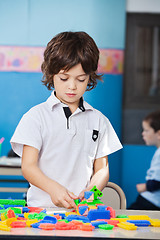 Image showing Boy Playing With Colorful Blocks In Classroom