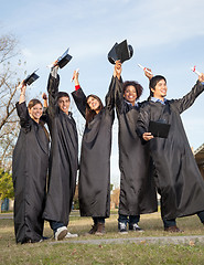 Image showing Students With Diplomas Celebrating Success On Graduation Day At