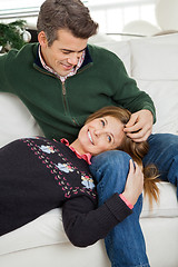 Image showing Couple Relaxing On Sofa During Christmas