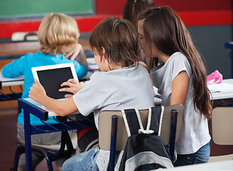 Image showing Schoolchildren Using Digital Tablet In Classroom