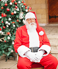 Image showing Man Dressed As Santa Claus Sitting In Front Of House