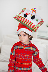 Image showing Boy Balancing Cushion On Head During Christmas