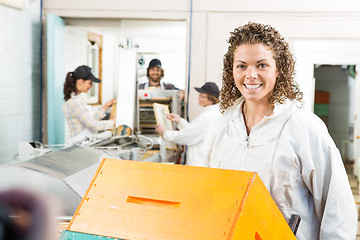 Image showing Female Beekeeper With Stacked Honeycomb Crates