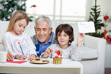 Image showing Boy Showing Letter While Grandfather Assisting Girl