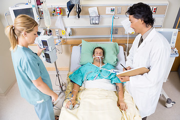 Image showing Doctor And Nurse Examining Critical Patient