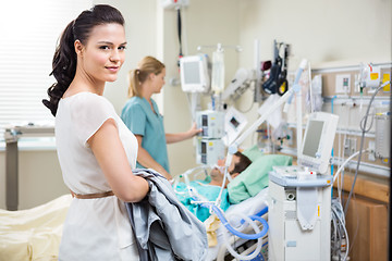 Image showing Woman With Nurse Examining Male Patient