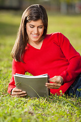 Image showing Woman Reading Book On Grass At University Campus