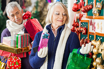 Image showing Woman Selecting Christmas Ornaments At Store