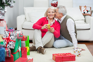 Image showing Woman Holding Christmas Present While Man About To Kiss Her