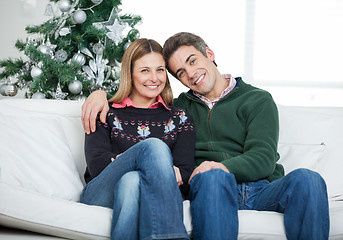 Image showing Loving Couple Sitting On Sofa During Christmas