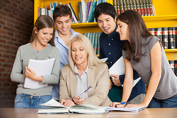 Image showing Teacher With Book Explaining Students In Library