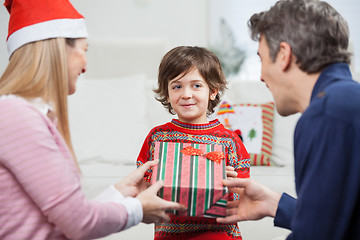 Image showing Boy Receiving Christmas Gift From Parents