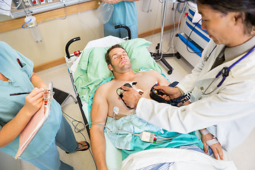 Image showing Doctor Defibrillating Male Patient In Hospital