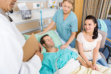 Image showing Woman Looking At Doctor While Holding Man's Hand