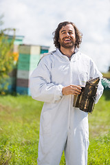 Image showing Happy Male Beekeeper Holding Smoker