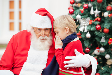 Image showing Boy Whispering In Santa Claus's Ear