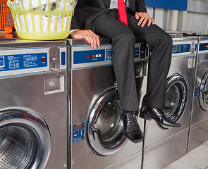 Image showing Businessman Sitting On Washing Machine