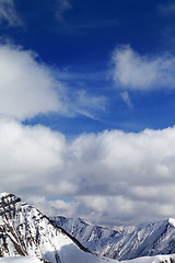 Image showing Winter snowy mountains in clouds at nice day