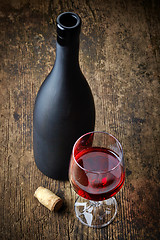 Image showing red wine and black bottle