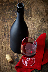 Image showing red wine and black bottle