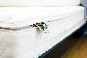 Image showing Cash hidden under the mattress