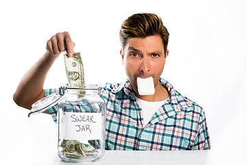 Image showing Man paying a swear jar