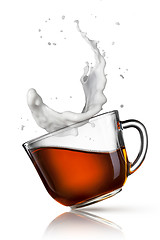 Image showing cup of black tea with milk splash isolated on white