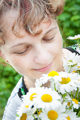 Image showing The woman with camomiles