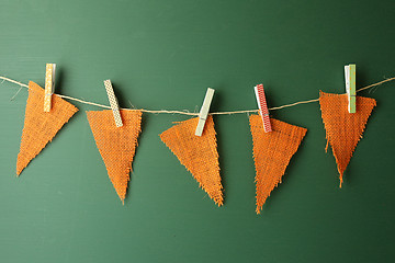 Image showing Burlap Pennants Hanging on a Green Chalkboard