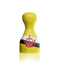 Image showing Wooden pawn with a painting of a flag