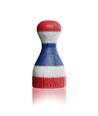 Image showing Wooden pawn with a painting of a flag