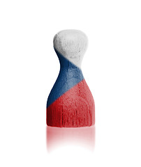 Image showing Wooden pawn with a painting of a flag