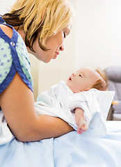 Image showing Loving Woman Looking At Cute Babygirl In Hospital