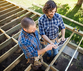 Image showing Carpenters Discussing Project On Digital Tablet