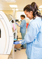 Image showing Medical Lab Tech Loading Coagulation Test