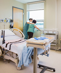 Image showing Nurse Comforting Pregnant Woman At Window In Hospital Room