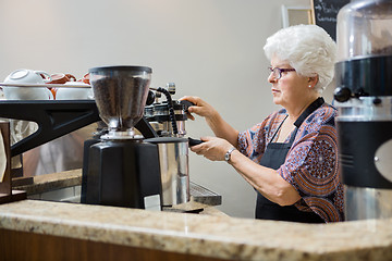 Image showing Barista Making Coffee In Cafe