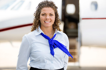 Image showing Beautiful Airhostess With Private Jet In Background